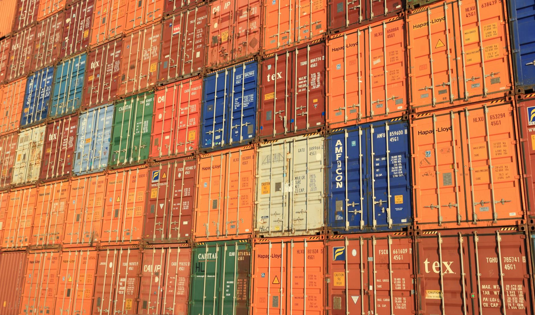 Colorful shipping containers stacked at port - choosing the right air freight forwarder for international logistics