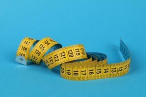Yellow measuring tape for cargo dimensions - how to measure LxWxH for air freight shipping