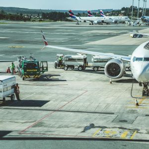 Ground crew preparing a commercial airplane at airport tarmac