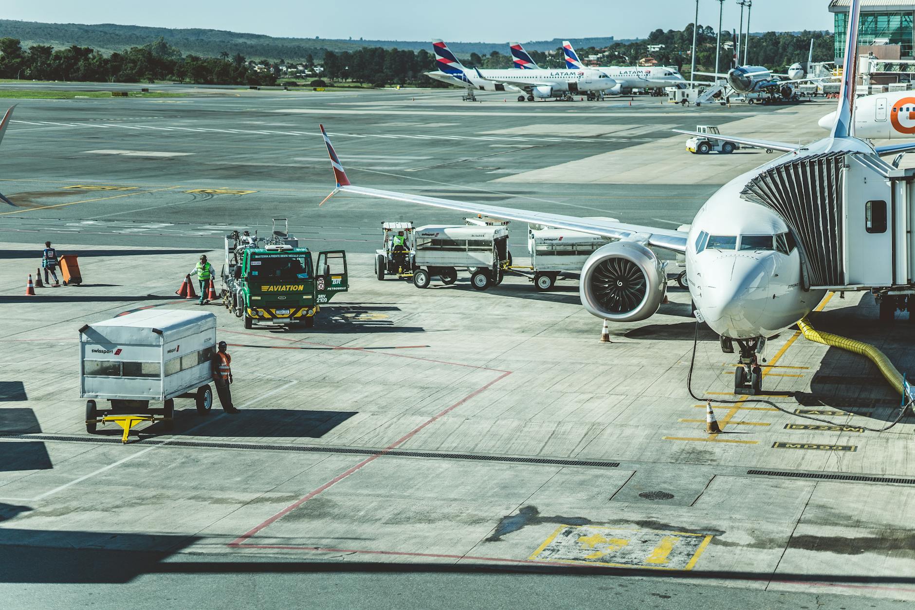 Ground crew preparing a commercial airplane at airport tarmac