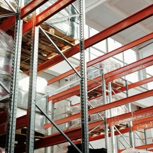 Warehouse with cargo pallets and storage racks - air freight consolidation combining shipments to save costs
