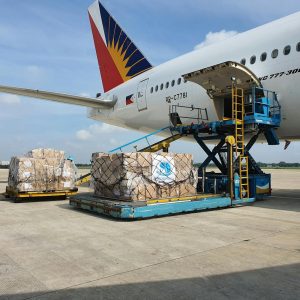 Cargo boxes being loaded onto a commercial airplane at airport