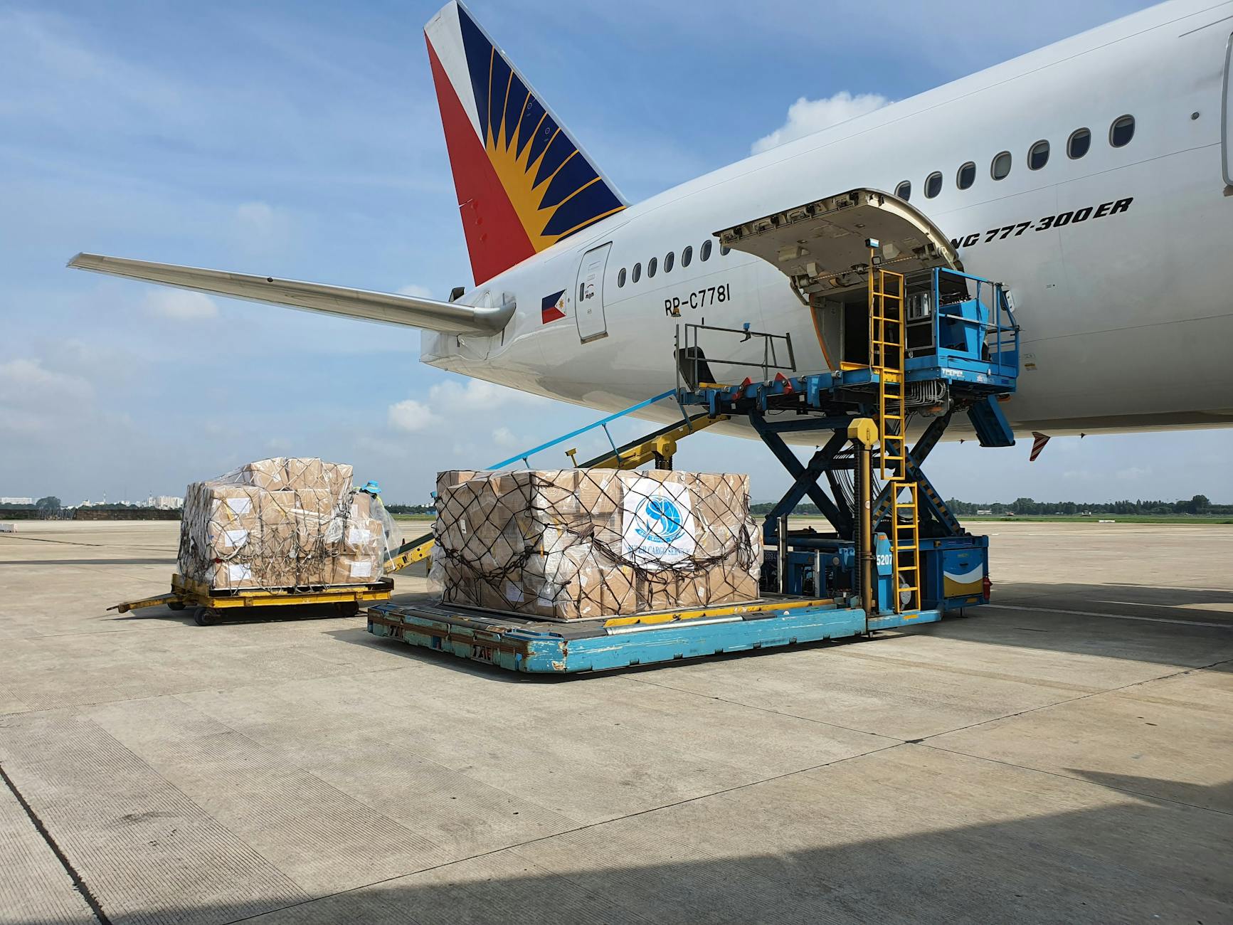 Cargo boxes being loaded onto a commercial airplane at airport