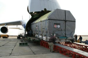 Cargo being loaded onto a large freighter aircraft at airport