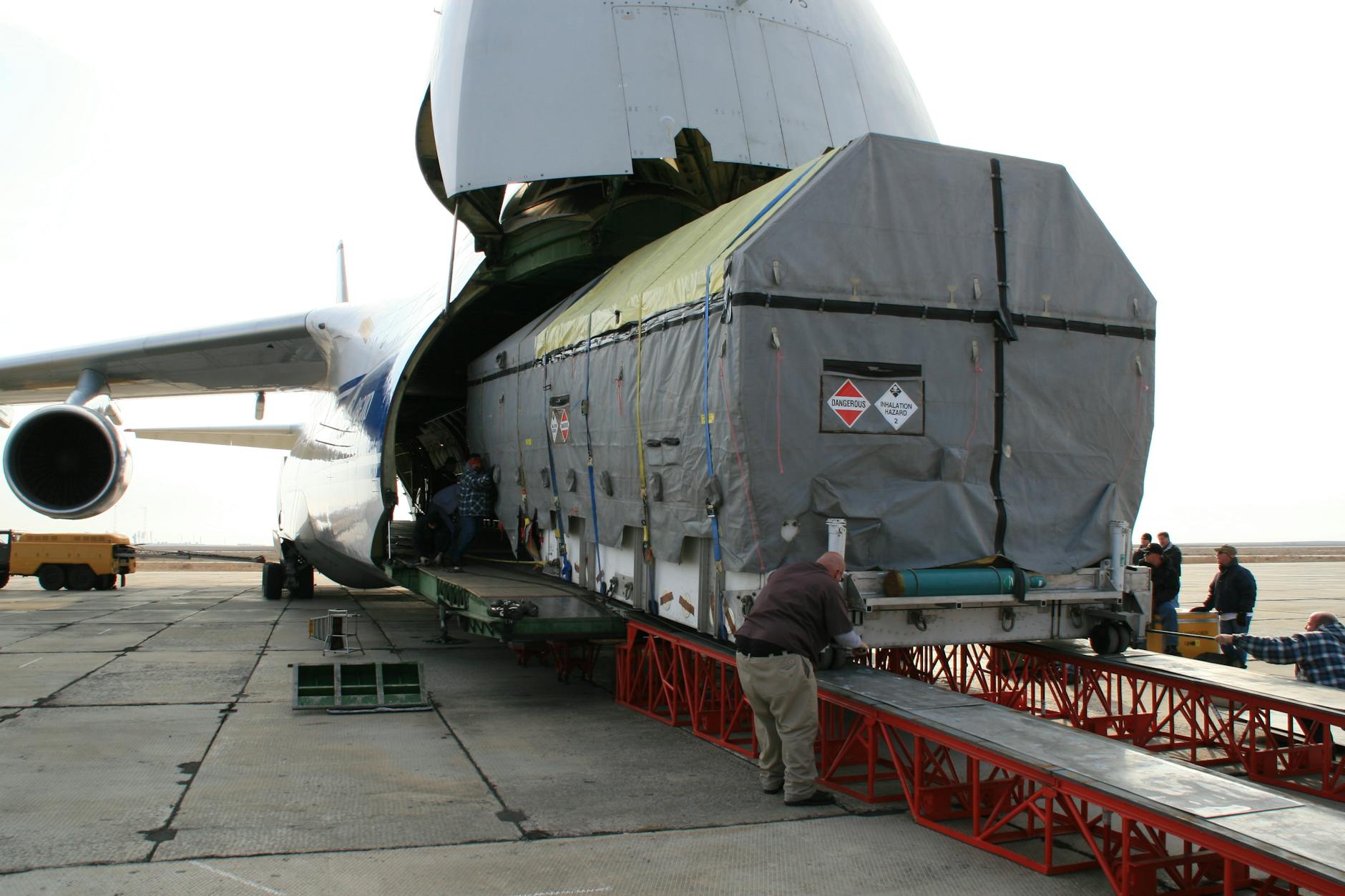 Cargo being loaded onto a large freighter aircraft at airport