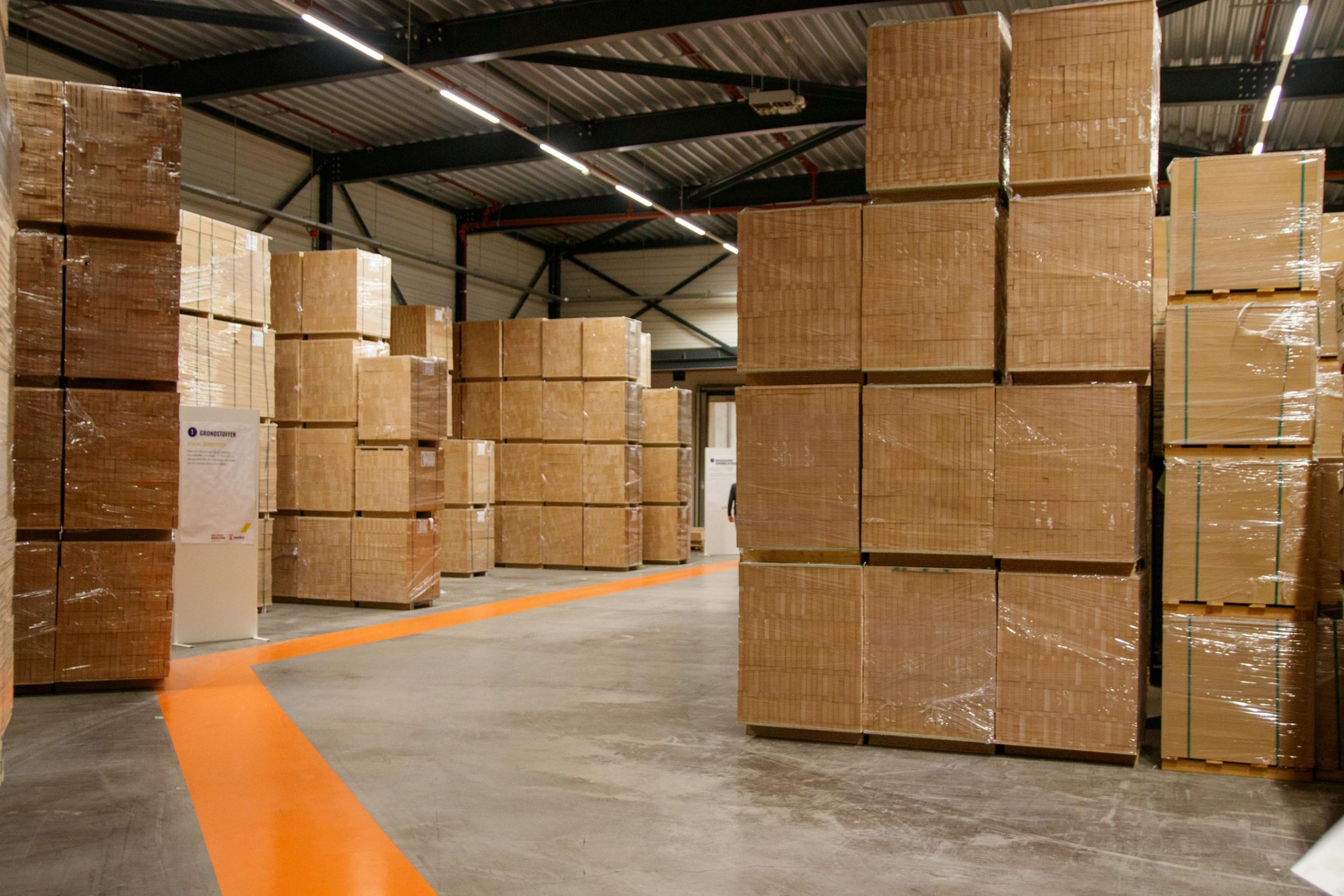 Spacious industrial warehouse filled with stacked cardboard boxes for air freight storage and shipping