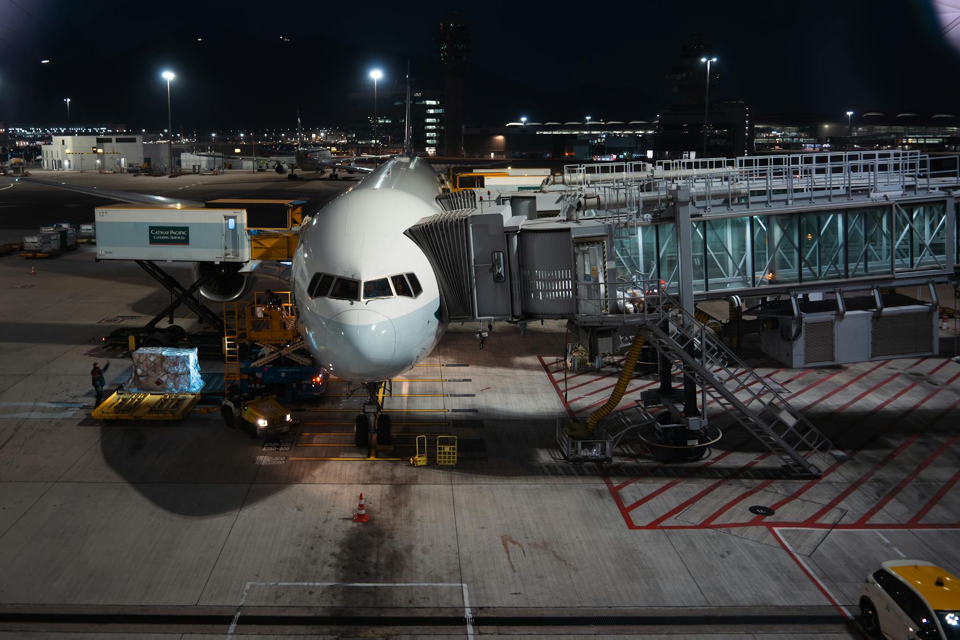 Cargo airplane at airport gate at night — air cargo rates and geopolitical tensions