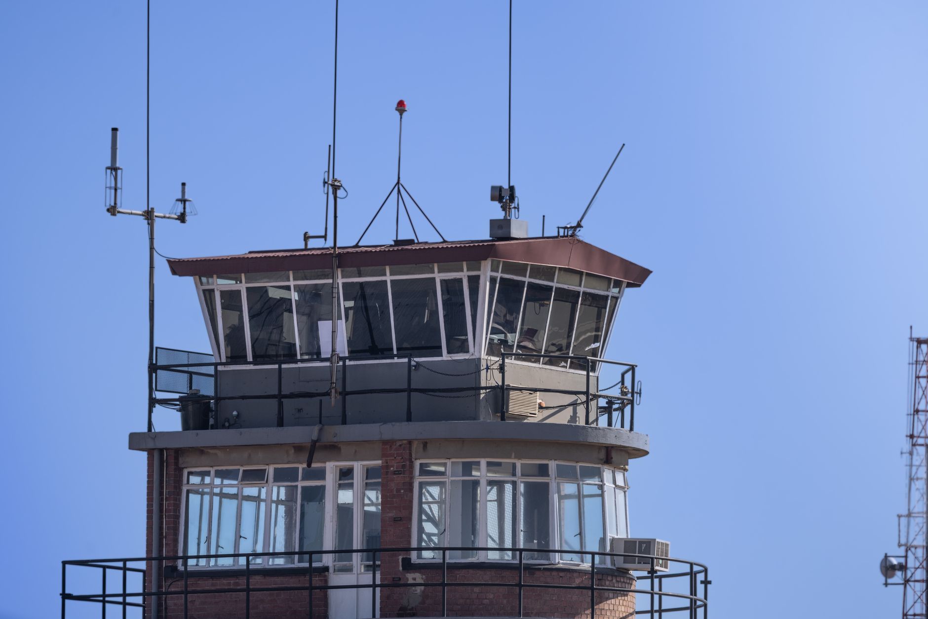 Airport control tower overseeing international cargo terminals